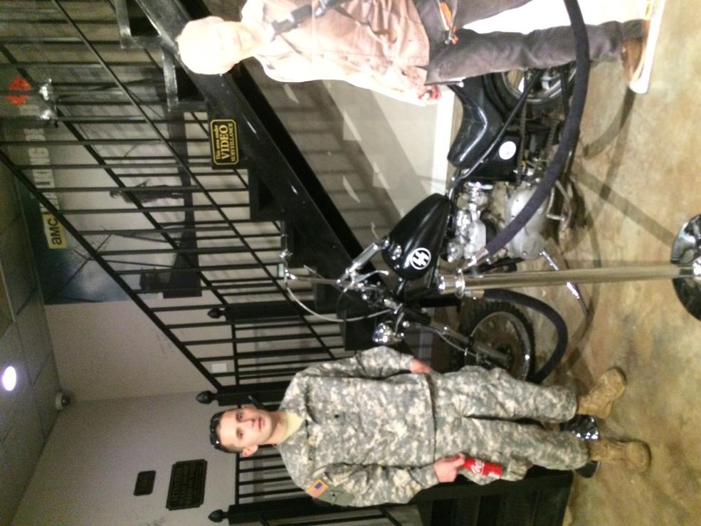 This is me next to Daryl dixons chopper and a cardboard cutout of him wish I could meet him in person but that's about as close as I'll probably get haha